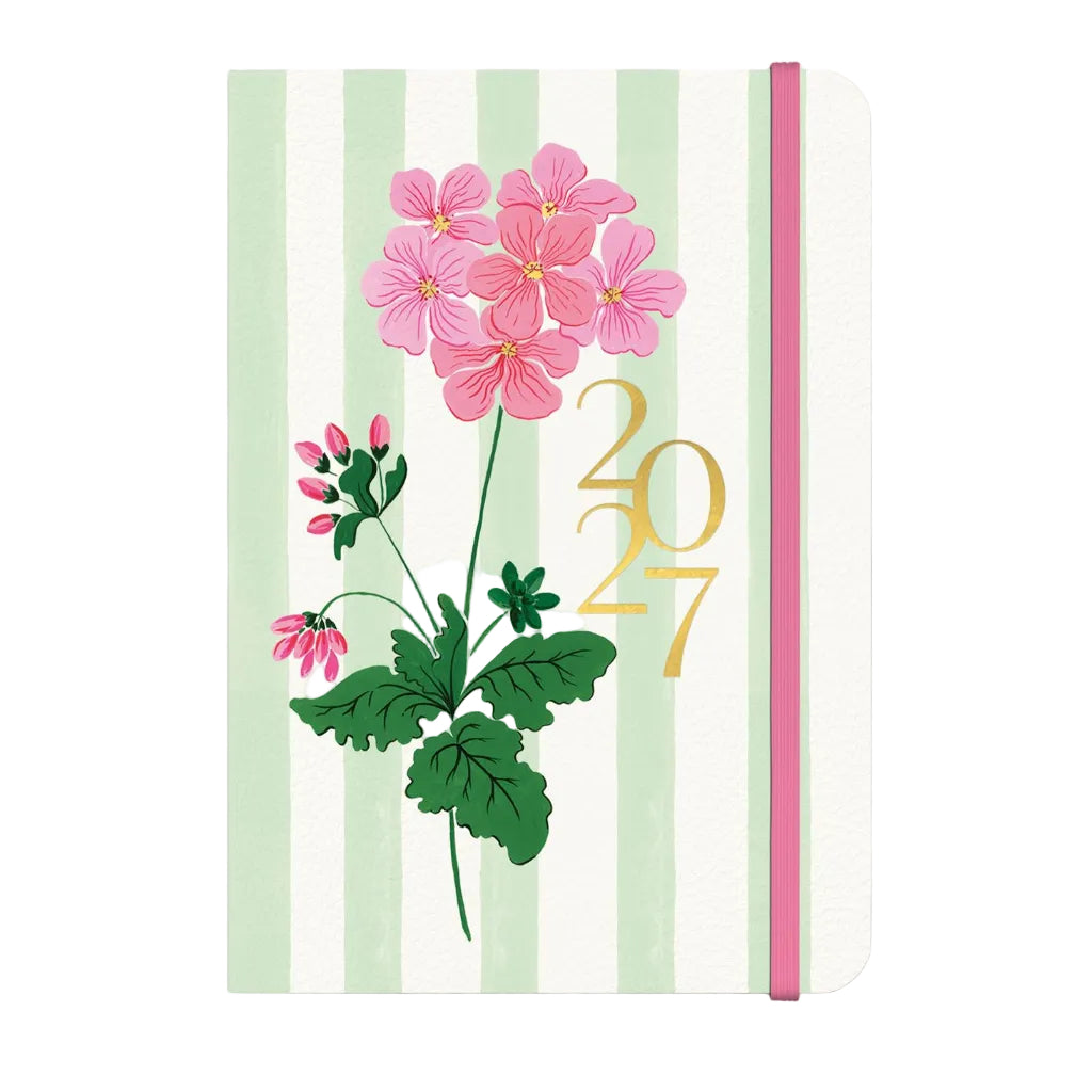 A 2027 daily planner with a white cover featuring vertical mint green stripes, pink flowers, green leaves, and a gold '2027' print. It has a pink elastic closure band on the right side.