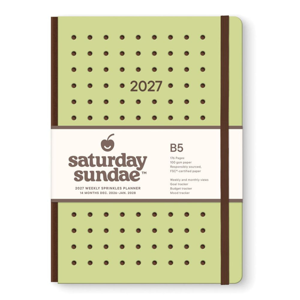 A 2027 B5 hardcover planner by Saturday Sundae, featuring a light olive green cover with brown polka dots and a white paper band around the middle.