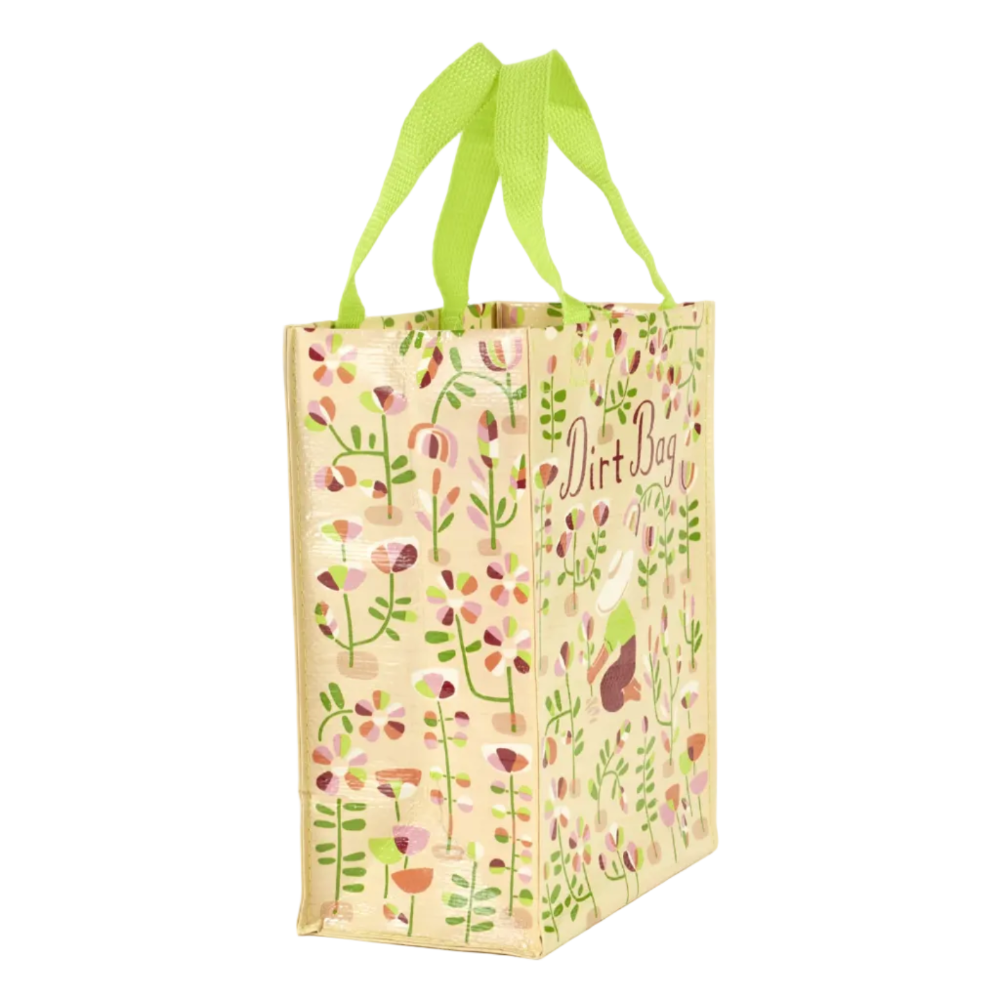 A reusable fabric shopping bag with bright lime green handles, featuring a beige background decorated with a colorful floral and botanical pattern and the words 'Dirt Bag' printed on the side.