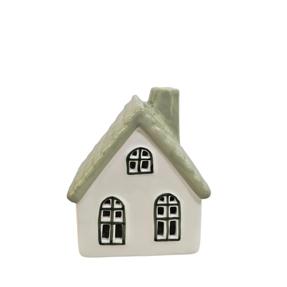 A small ceramic house figurine with a white body, a textured light green roof, and black window details, shown against a solid light gray background.