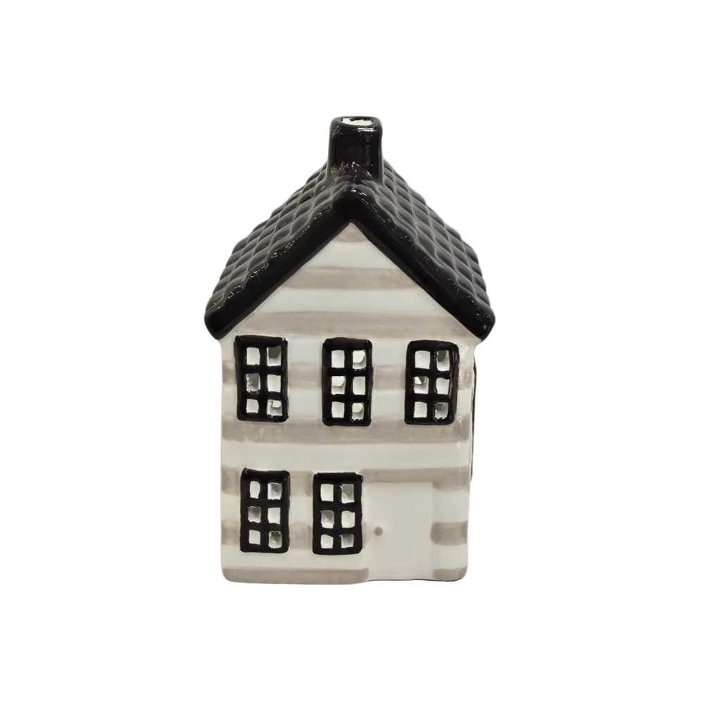 A small ceramic house-shaped candle holder or decorative figurine with a white body, black roof, and black window details, shown against a plain light gray background.