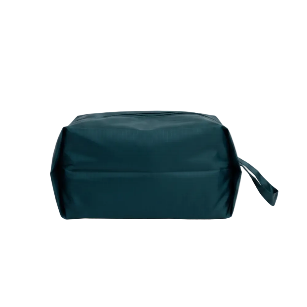 Green toiletry bag on a light gray background