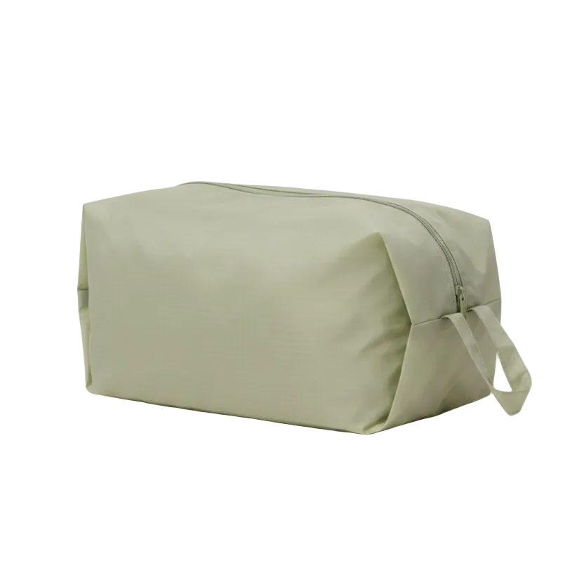 Baggu Green toiletry bag on a white background