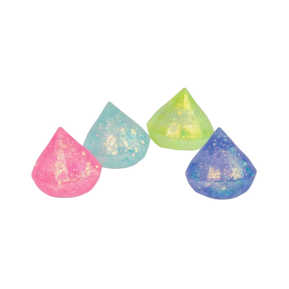 Four teardrop-shaped glitter makeup sponges in pink, light blue, lime green, and purple, arranged on a plain white background.