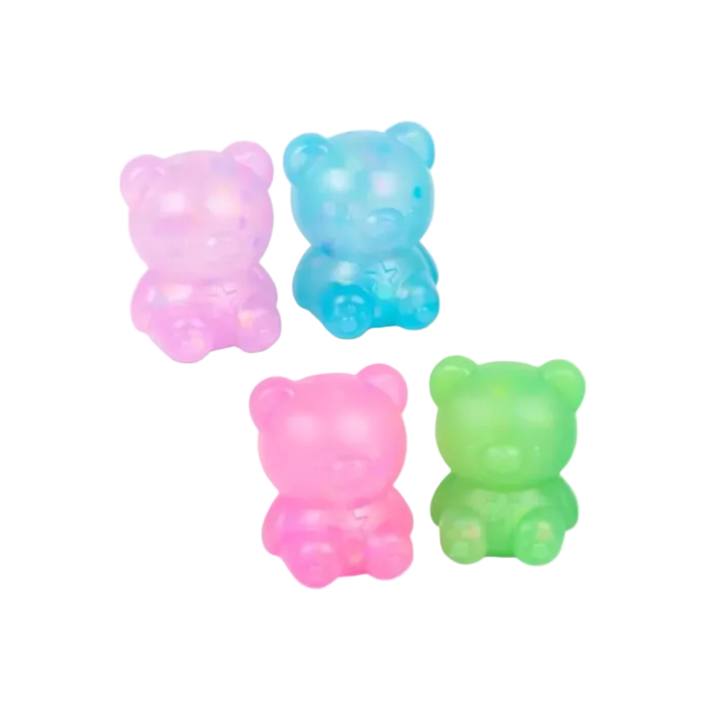 Four translucent teddy bear-shaped glow-in-the-dark toys in pink, blue, and green, arranged on a plain white background.