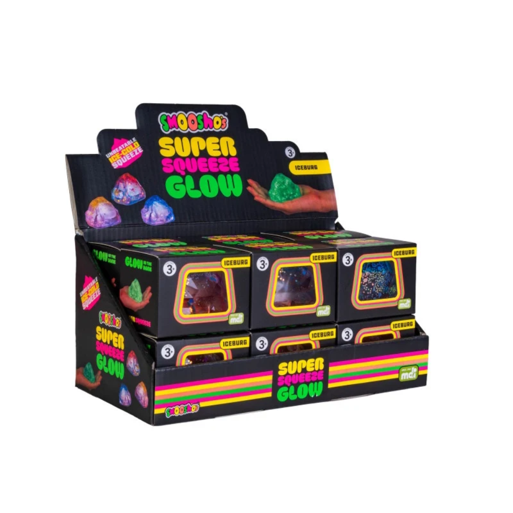 A retail display box filled with multiple small black boxes of MooShoos Super Squeeze Glow toys, photographed on a plain white background.