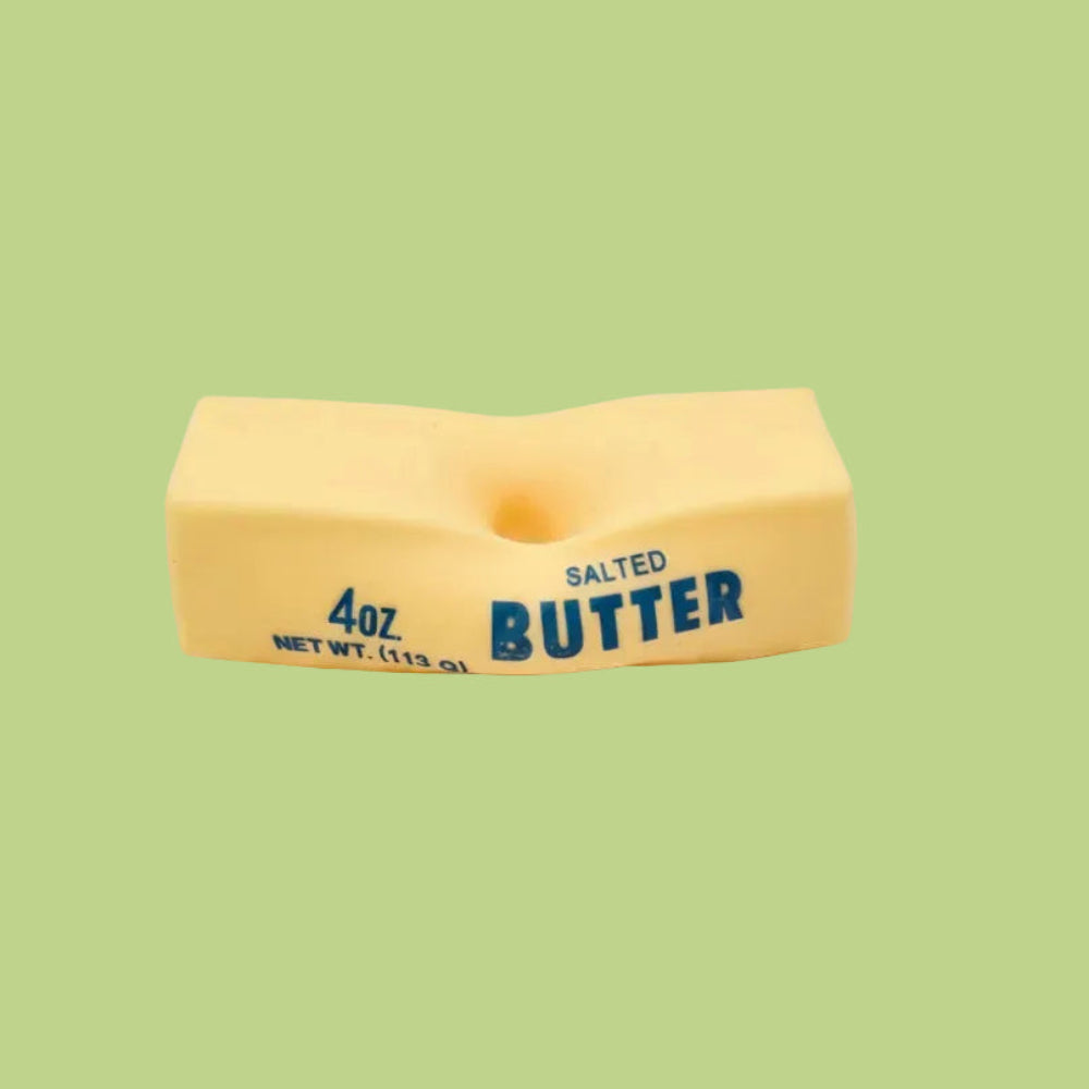 A novelty salted butter squishy toy featuring blue printed text that reads '4oz' and 'SALTED BUTTER'