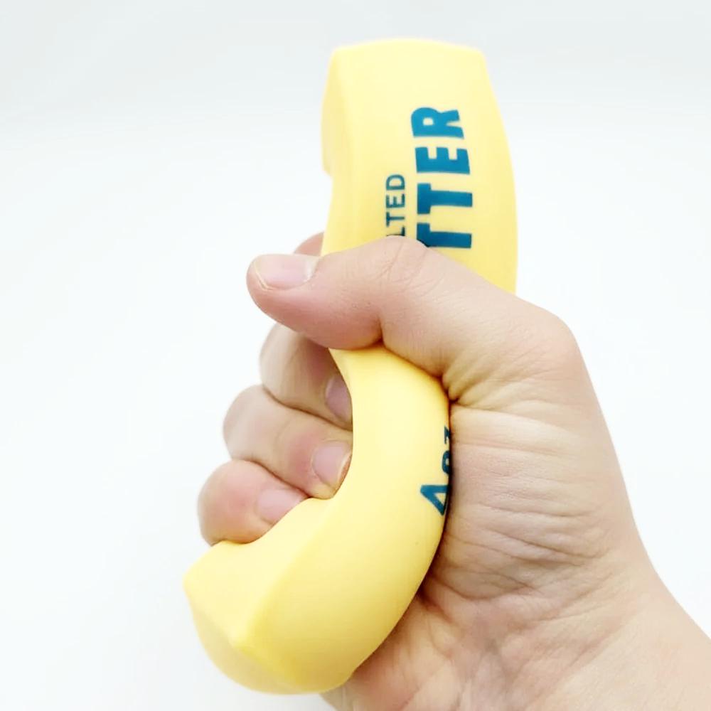A hand holding a yellow salted butter bar with blue text, shown against a plain light gray background.