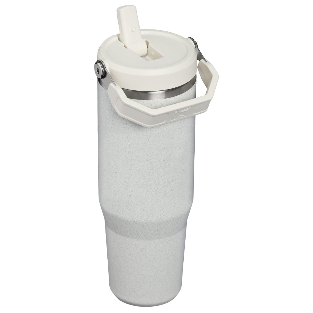 A tall, insulated travel tumbler in a light gray speckled finish, featuring a white lid with a flip-up straw and a carrying handle, set against a plain white background.