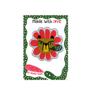 A decorative enamel pin shaped like a flower with a leopard face in the center, mounted on a branded backing card. The pin has red petals, a yellow and black spotted face, and a green badge that reads 'FUCK OFF.