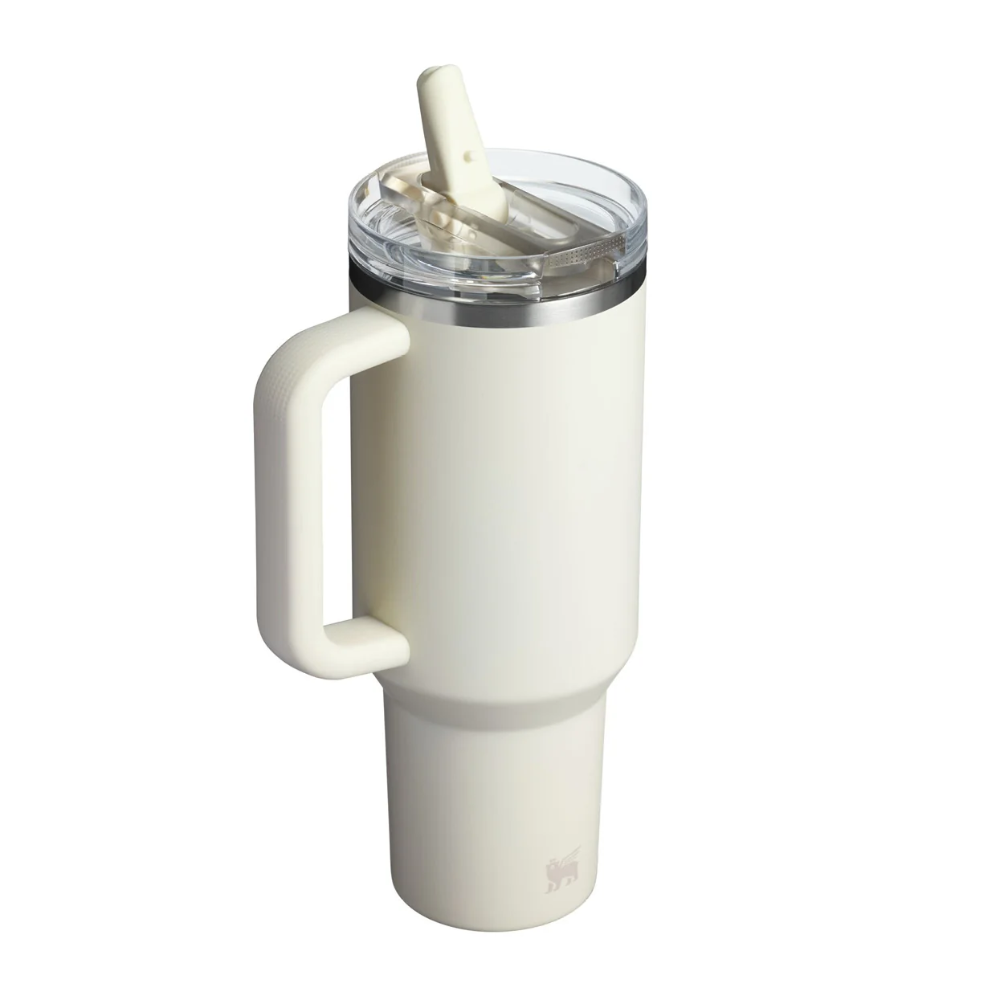 An off-white insulated travel tumbler with a large integrated handle, a clear lid, and a cream-colored straw, shown on a solid white background.