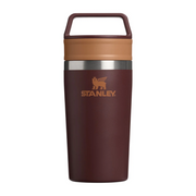 Stanley insulated travel tumbler in dark brown with a tan lid and handle, featuring the Stanley logo on the front.