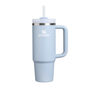 A light blue Stanley travel tumbler with a handle, a white lid, a clear straw, and a silver band, shown on a plain white background.
