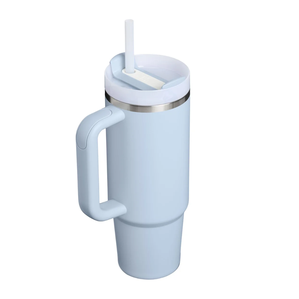 A light blue insulated travel tumbler with a matching handle, lid, and straw, featuring a thin metallic silver band near the lid, shown on a solid white background.