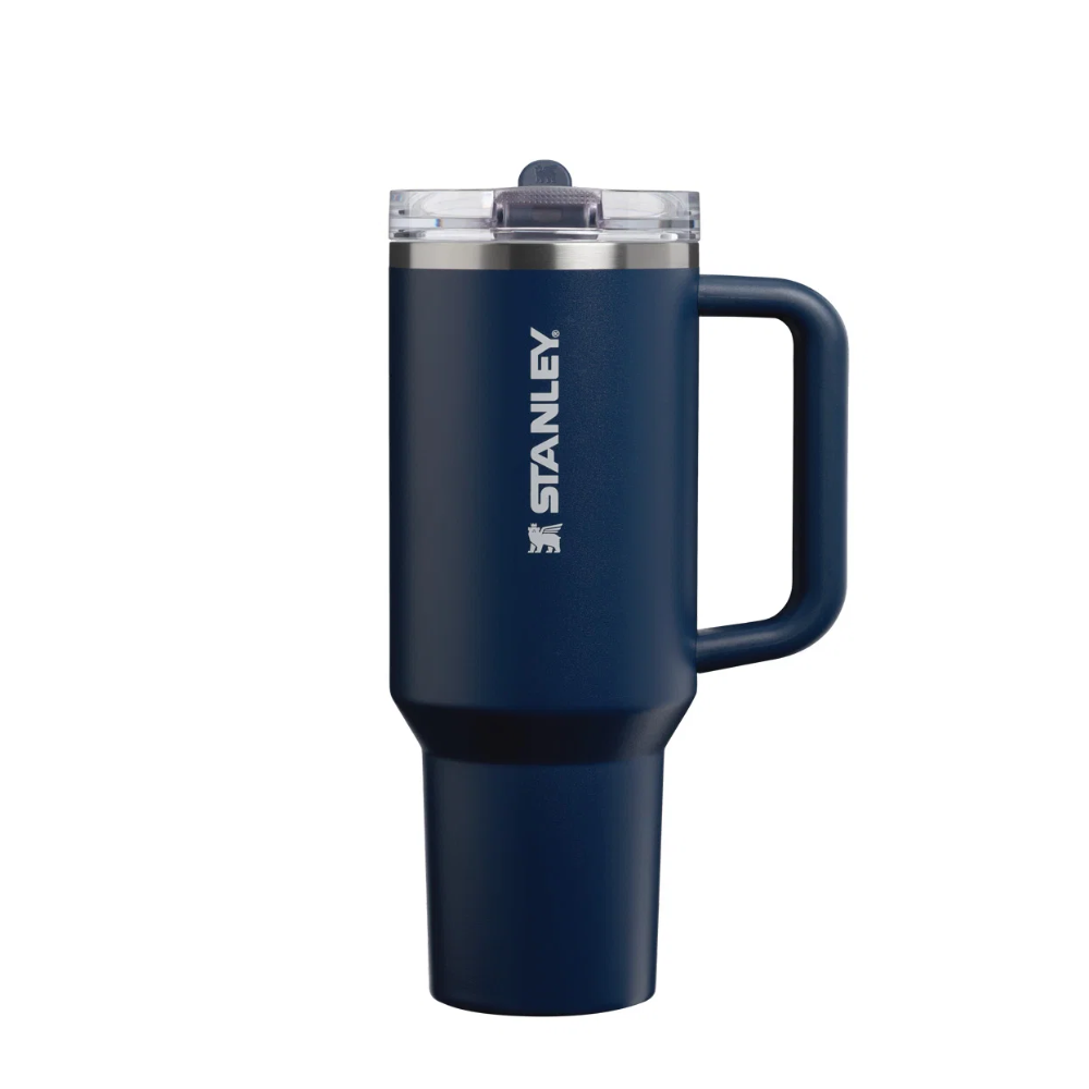 A navy blue Stanley travel mug with a handle, clear lid, and white Stanley logo on a solid white background.