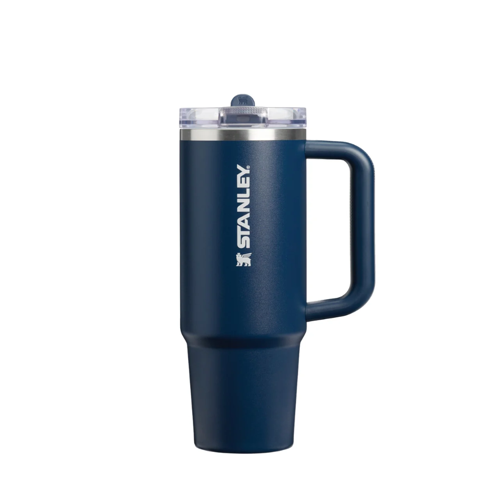 A navy blue Stanley travel mug with a handle, clear lid, and white Stanley logo on the side, shown against a plain white background.