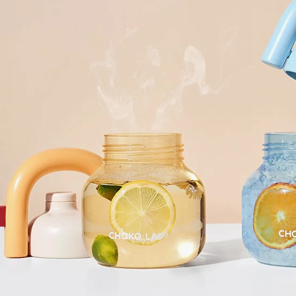 Decorative jars with lemons and limes on a neutral background