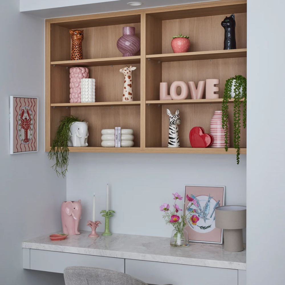 Decorative shelves with various items including vases, a 'LOVE' sign, and a pink elephant figurine.