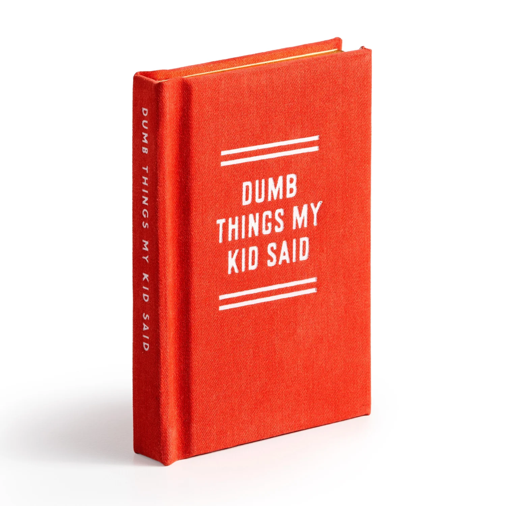 A hardcover book with a textured red-orange linen cover and white text reading 'DUMB THINGS MY KID SAID' on the front cover and spine, photographed on a clean white background.