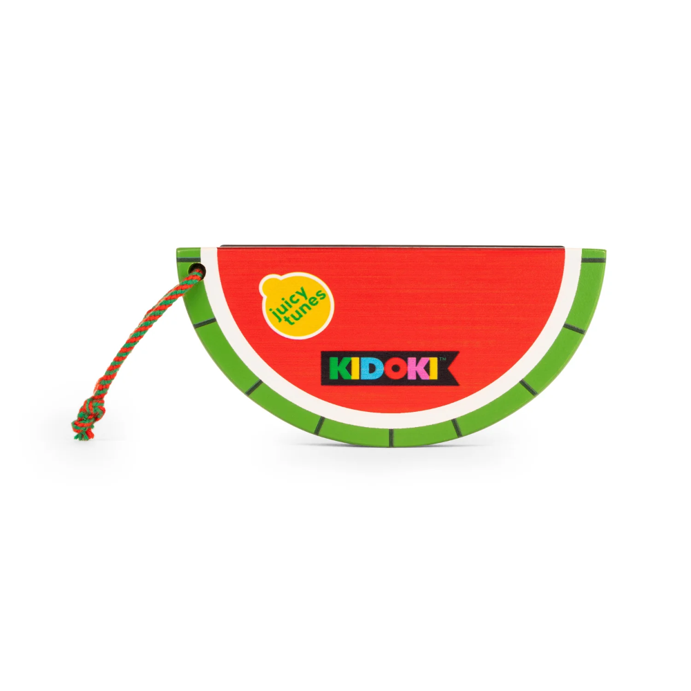 A watermelon-themed coin purse by Kidoki, featuring a red center, green rind, a yellow sticker that reads 'Juicy Fruits,' and a colorful braided strap, shown on a plain white background.