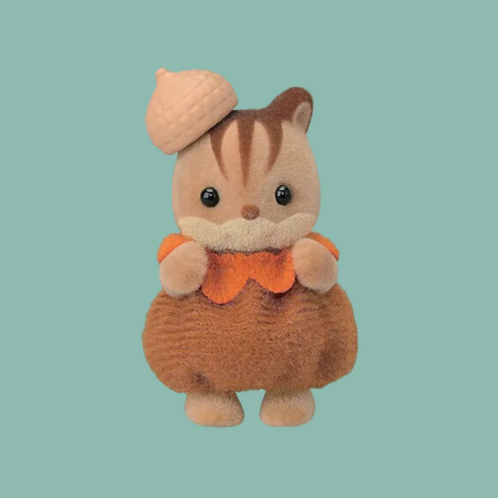 A small plush toy of a brown and beige squirrel wearing an orange collar and holding a tan acorn, centered on a plain white background.