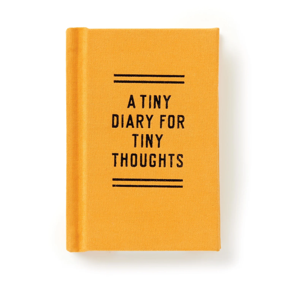 A small yellow-orange hardcover notebook or diary with black text reading 'A TINY DIARY FOR TINY THOUGHTS' and black horizontal line accents on the front cover, shown on a clean white background.