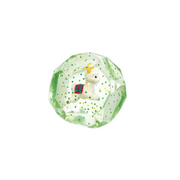 A clear faceted crystal ball ornament featuring a small white llama figurine with a red and green saddle and a yellow horn, set against a plain white background.