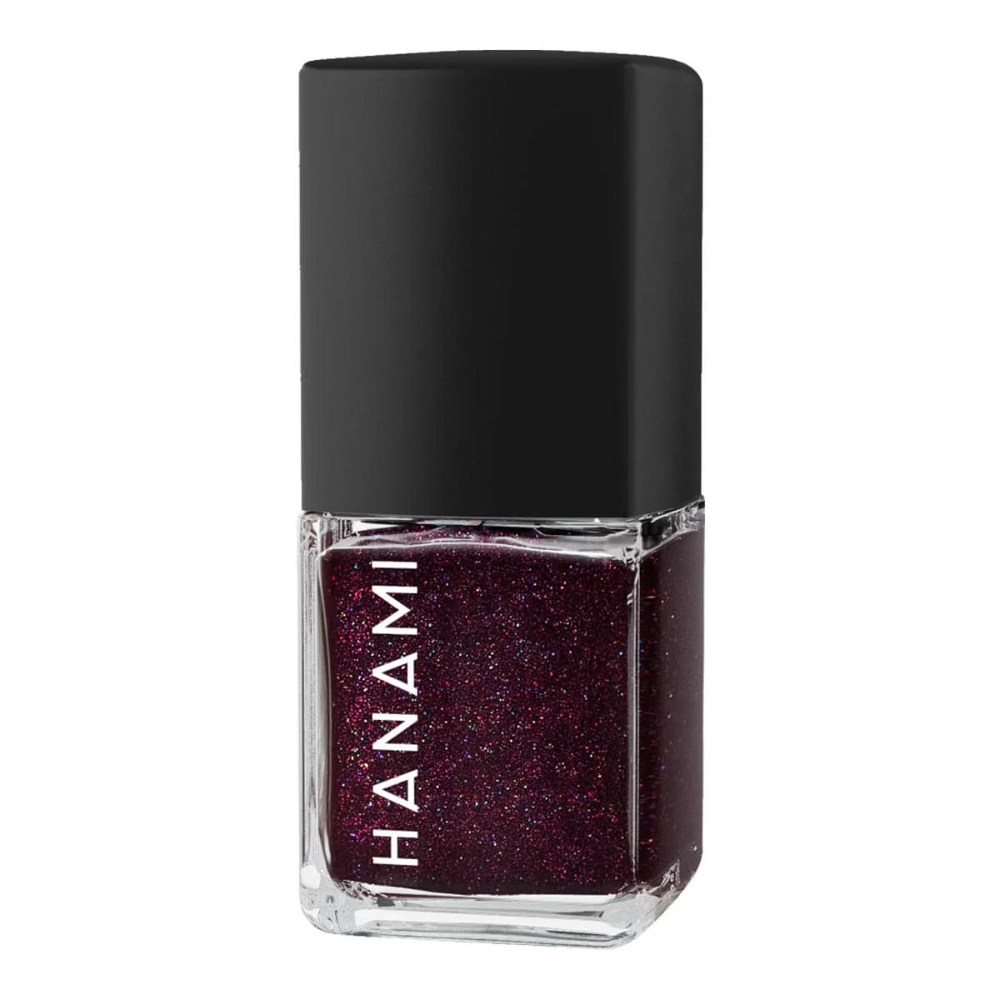 Nail polish bottle with black cap and dark purple glittery polish on a white background