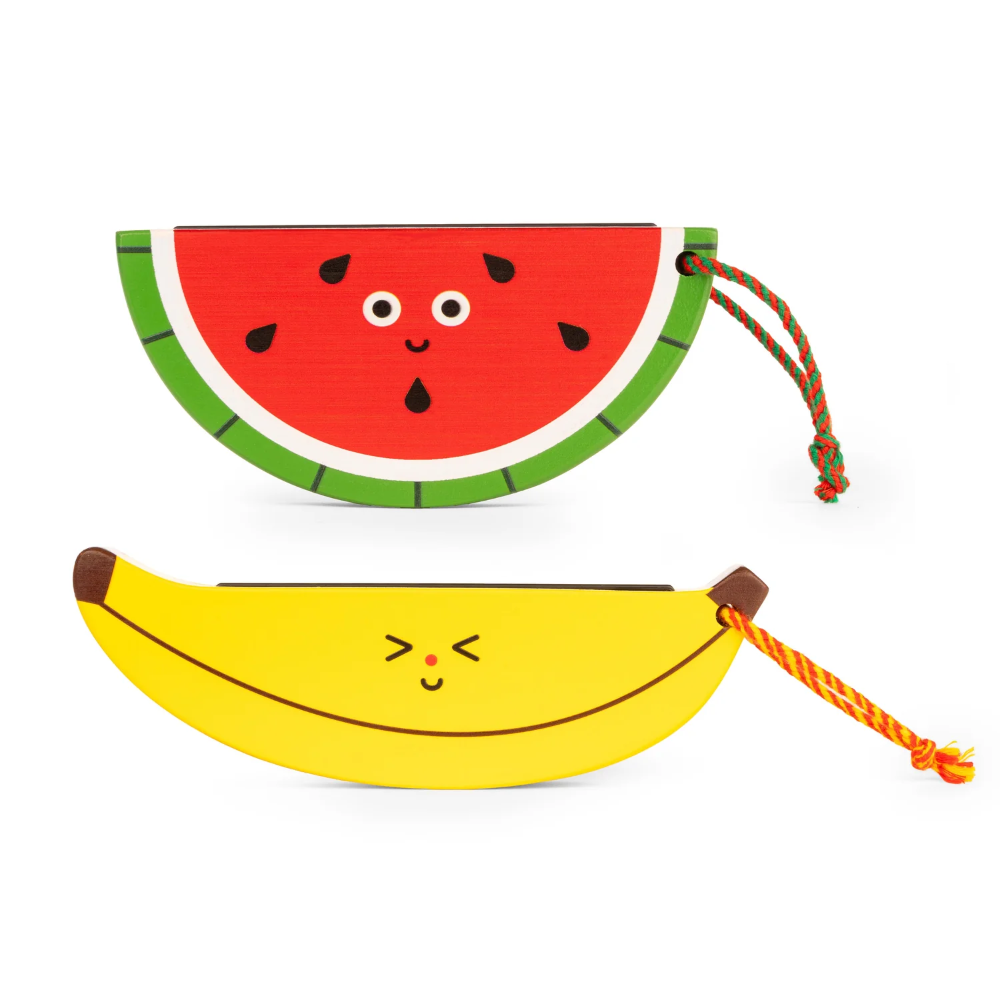 Two novelty harmonicas shaped like a watermelon slice and a banana with faces on a white background.