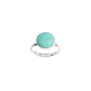 A sterling silver ring featuring a round turquoise cabochon stone