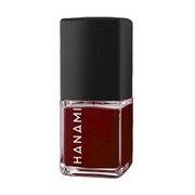 A bottle of Hanami nail polish in a deep burgundy red shade, featuring a black cap and a clear glass base with the brand name 'HANAMI' printed vertically in white.