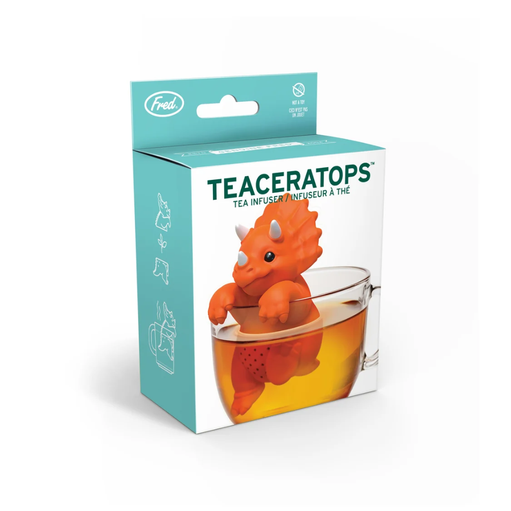 Teaceratops tea infuser packaging with a dinosaur-shaped tea bag in a glass of tea.