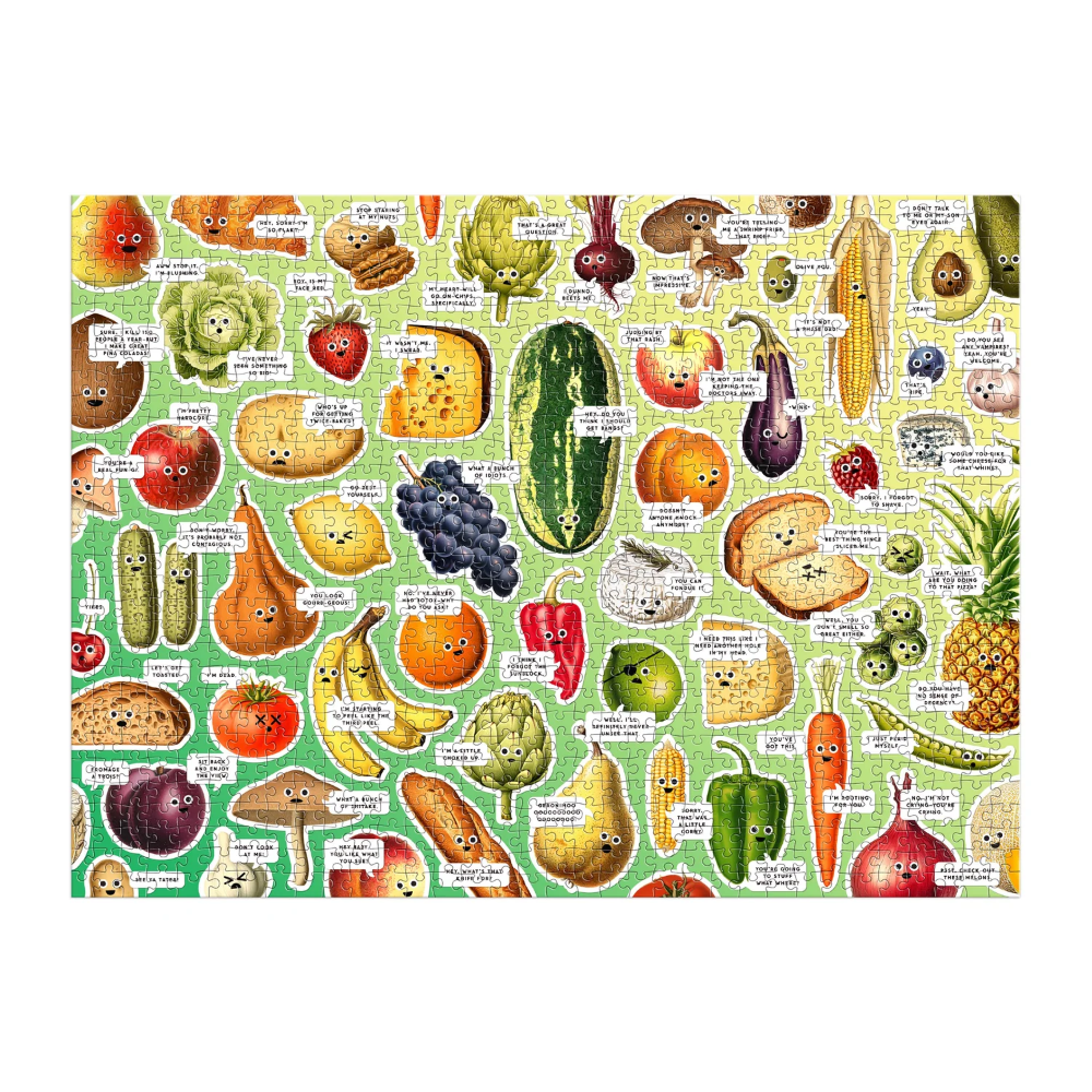 A square fabric placemat or table runner featuring a colorful cartoon illustration of various fruits and vegetables on a light green grid background. The playful design includes smiling apples, bananas, carrots, grapes, and mushrooms, surrounded by a white border on a white background.