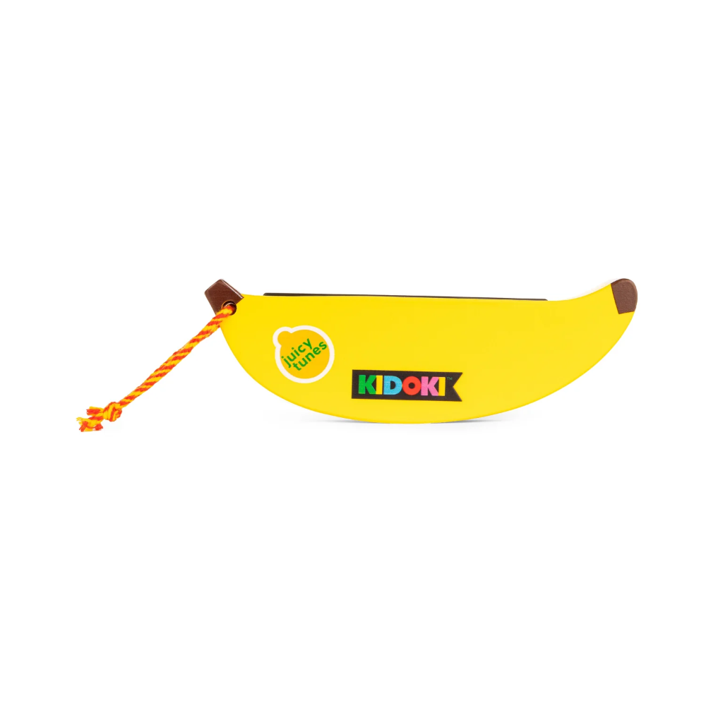 A yellow banana-shaped harmonica pouch with brown ends, an orange braided rope, and stickers reading 'Nicky Nanny' and 'KIDOKI', shown on a plain white background.