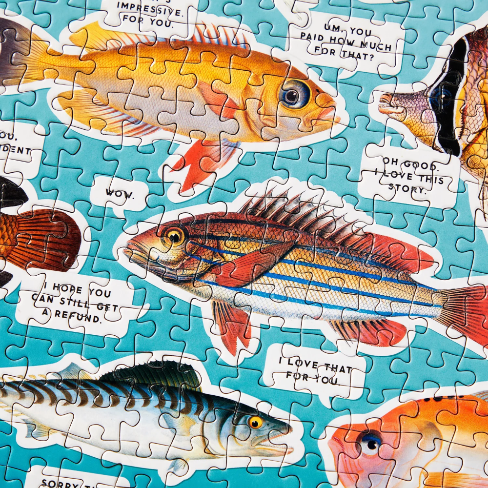 Jigsaw puzzle with fish illustrations and humorous text on a blue background