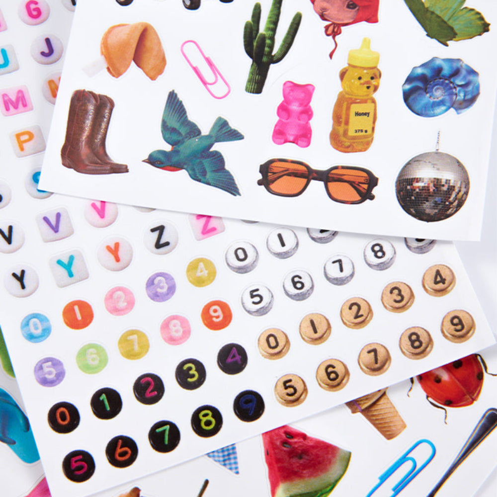 Collection of various stickers including numbers, animals, and objects on a white background.