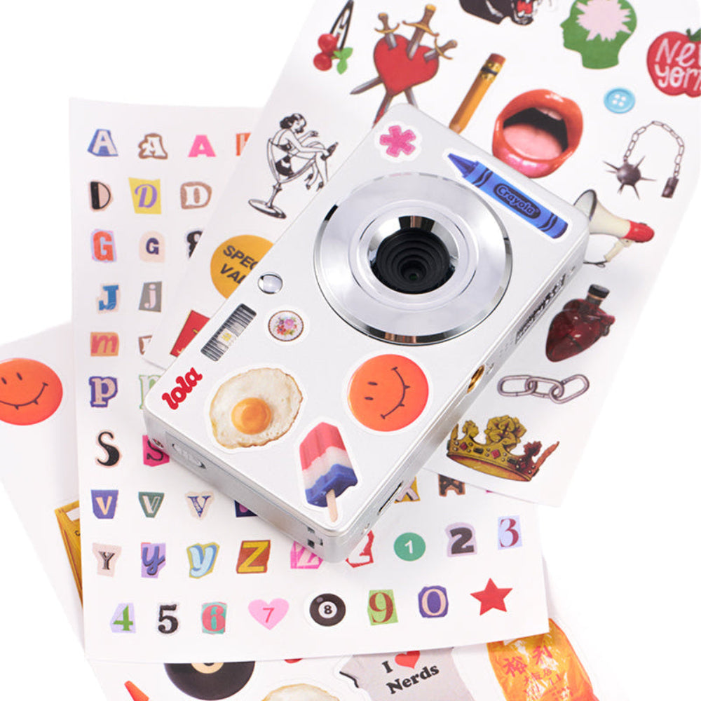Small camera with colorful stickers on a white background