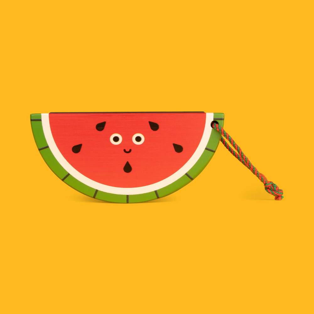 Watermelon-shaped toy with a face on a yellow background