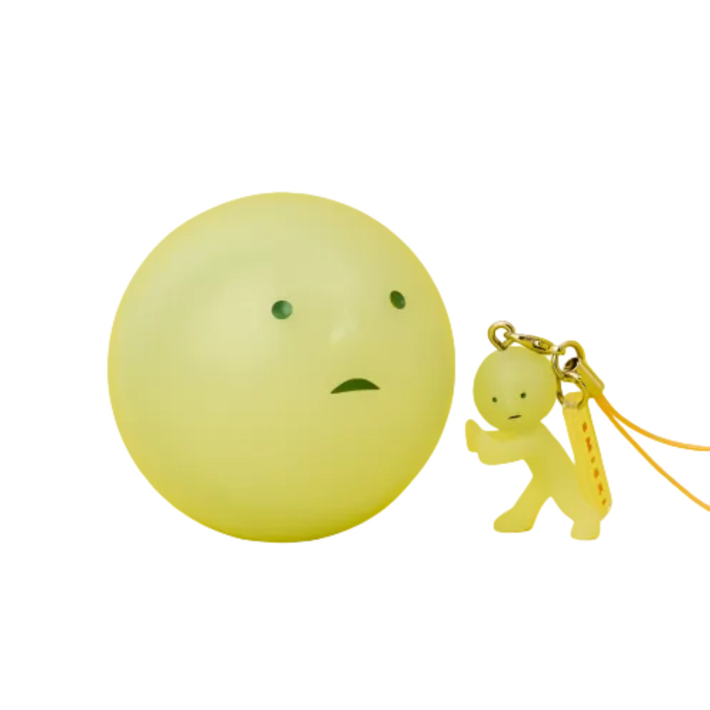 Two sides of a glowing ball with a small figure attached, one on a yellow background and the other on a green background.