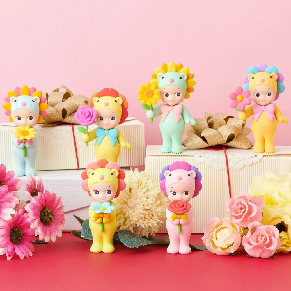 Colorful toy figures with flowers on a pink and red background