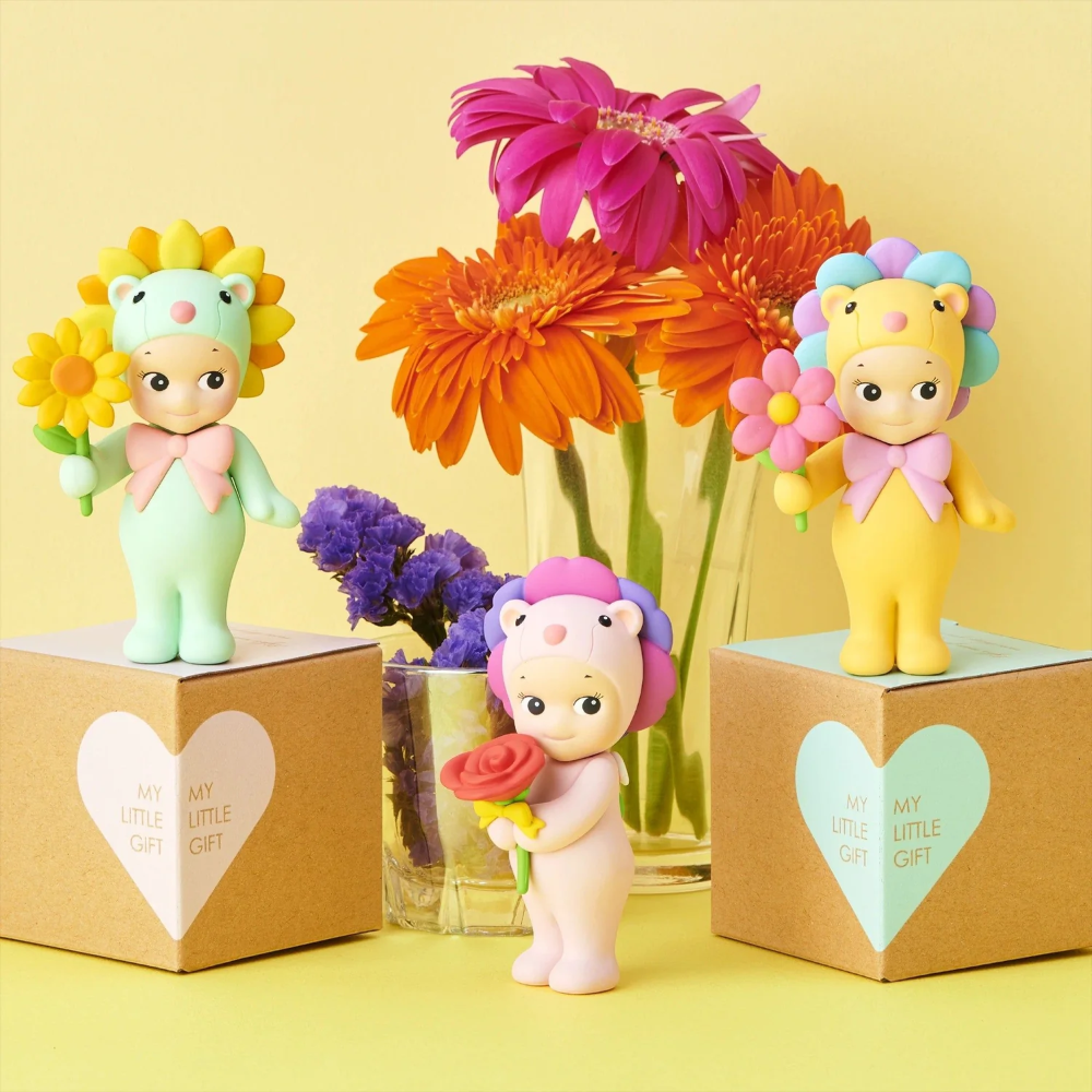 Toy figures with flowers on a yellow background