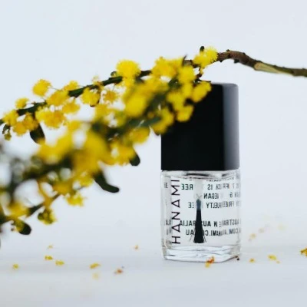 Skincare bottle with yellow flowers on a light background