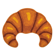 Decorative rug shaped like a croissant on a white background
