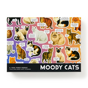 A 1000-piece jigsaw puzzle box titled 'MOODY CATS' featuring a colorful pattern of illustrated cats with humorous speech bubbles, set against a plain white background.