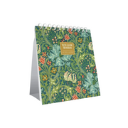 William Morris 2017 desk calendar standing upright on its side, featuring a green and blue floral pattern with birds and a gold label on the front.