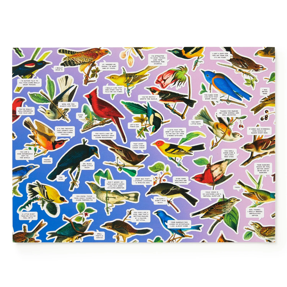 Patterned fabric with colorful birds and leaves on a blue and purple background